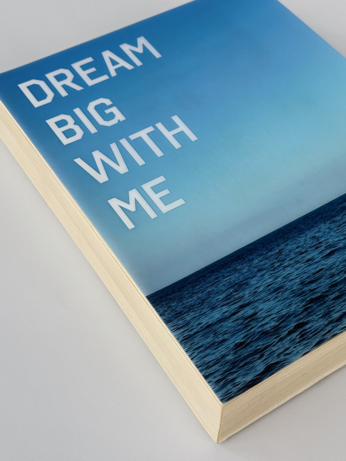 Side Profile: 'Dream Big With Me' limited edition mixed media artwork by Christen Oatley, featuring a yellow parasail over the Mediterranean Sea with bold white acrylic text, created on an 8x10 inch Canadian birchwood panel with resin finish.