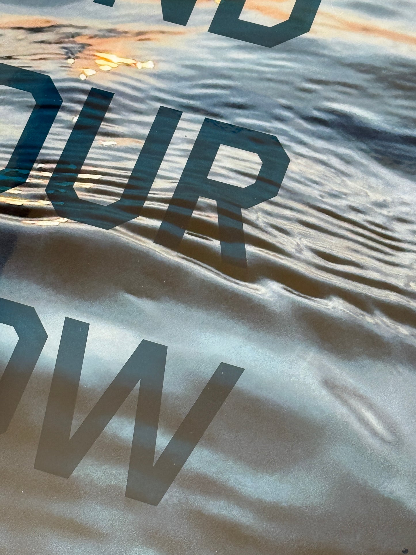 Close up: 'Find Your Flow – Dusk' original mixed media artwork by Christen Oatley, featuring a Muskoka sunset over Lake Joseph with translucent navy screen-printed text on photography, finished with resin on a 24x30 inch Canadian birchwood panel.