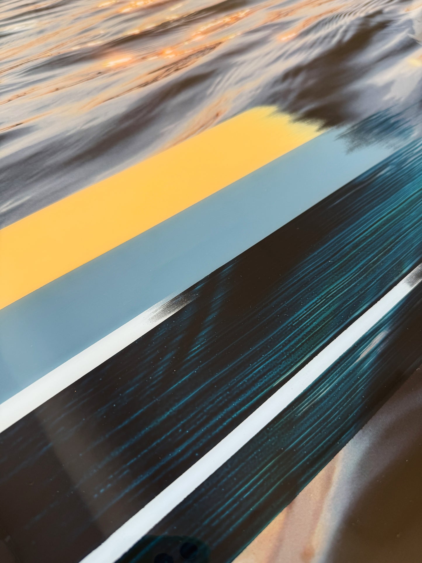 Close-up of 'Sunset Tones' original mixed media artwork by Christen Oatley, showing layered acrylic and oil brushstrokes over a Lake Joseph sunset photograph, finished with a glossy resin coat on birchwood panel.