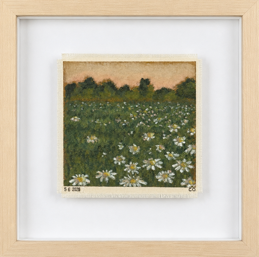 Framed artwork of a field with flowers