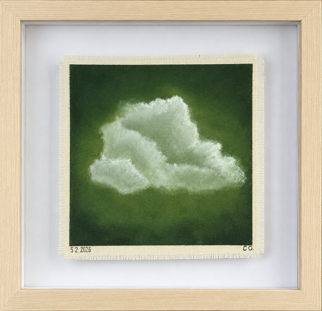 Framed artwork of a cloud on a green background
