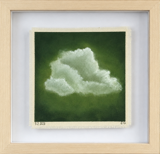 Framed artwork of a cloud on a green background