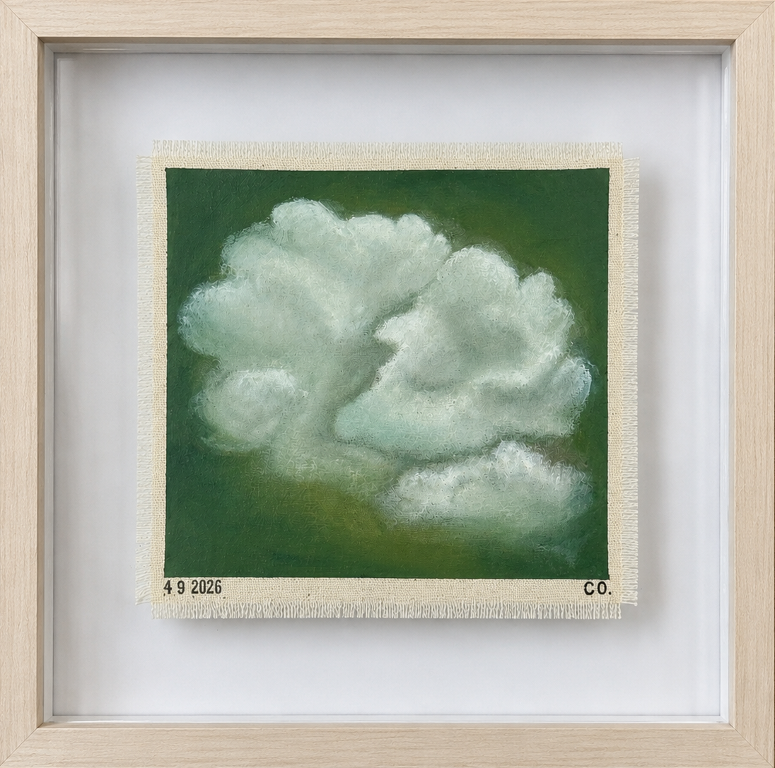 Framed artwork of a cloud on a green background